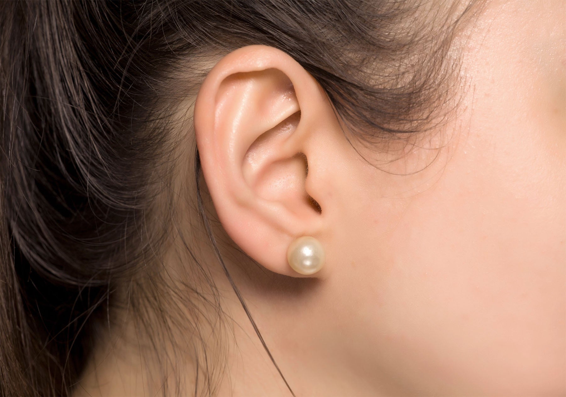 עגילי פנינה וזהב 14 קראט על האוזן למראה נשי ואצילי