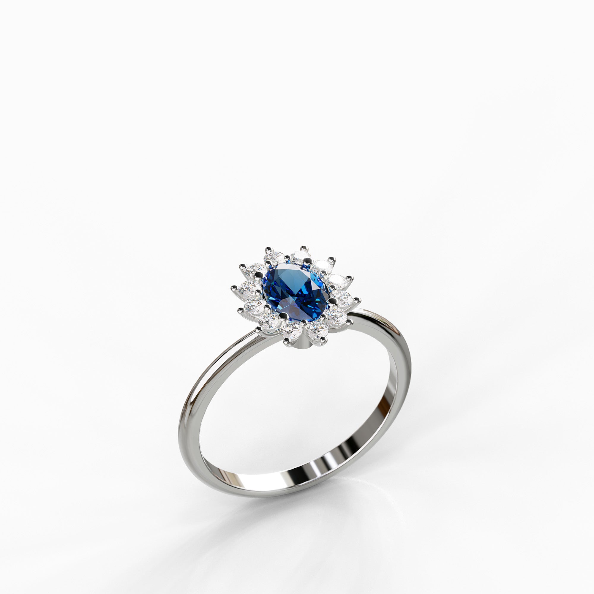 טבעת Diana מזהב לבן בשיבוץ אבן ספיר כחולה מרכזית והילת יהלומי צד