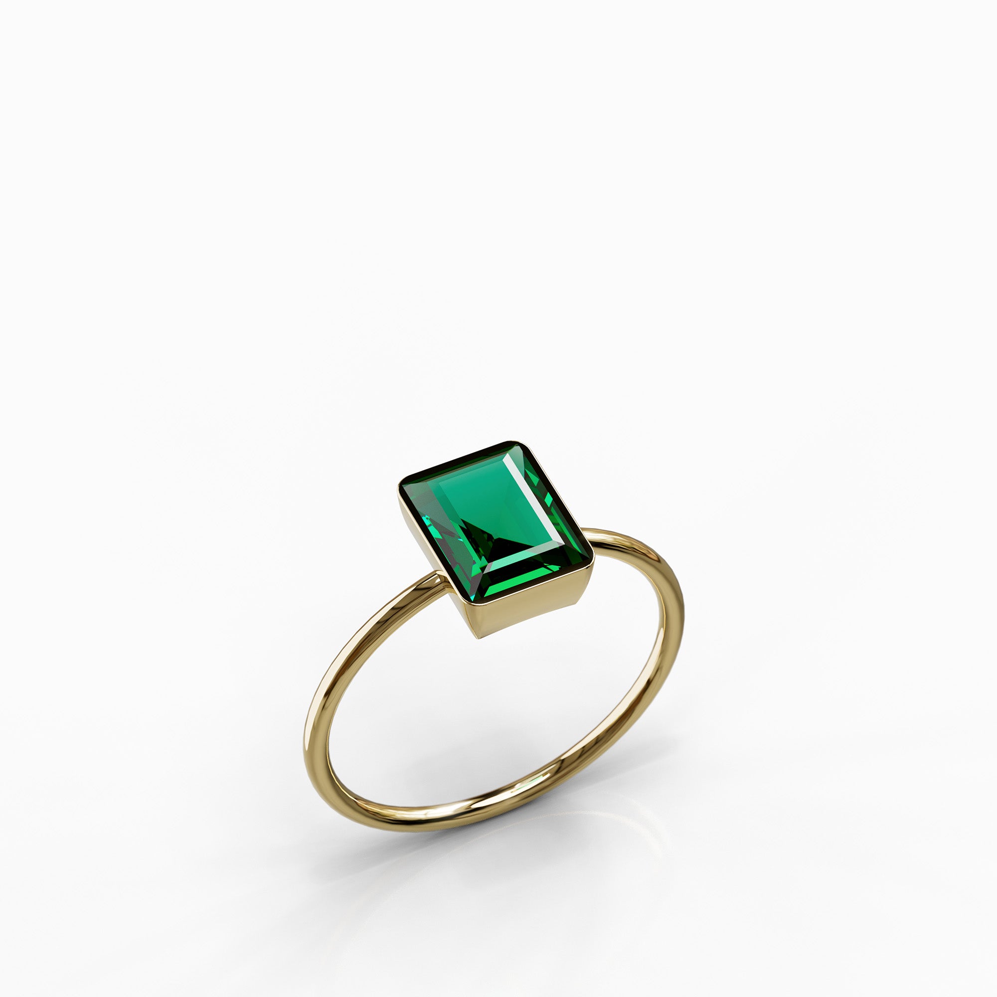 טבעת Oasis מזהב צהוב בשיבוץ אמרלד מלבנית בעיצוב מודרני